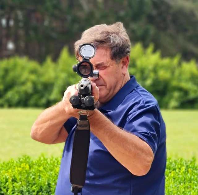 Hunter aiming a rifle fitted with a Real Shot reel